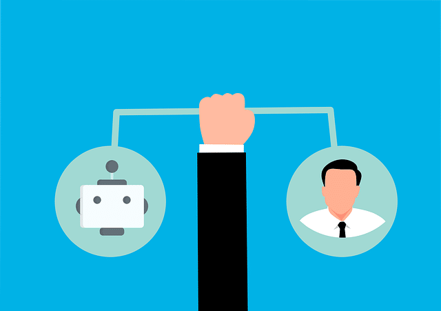 Hand holding a link between two bubbles, one with a robot looking face and one with a human face.